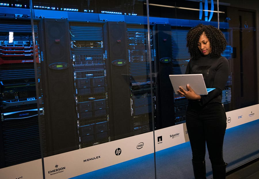 Electricity Grid, data centres, software engineer standing beside server racks